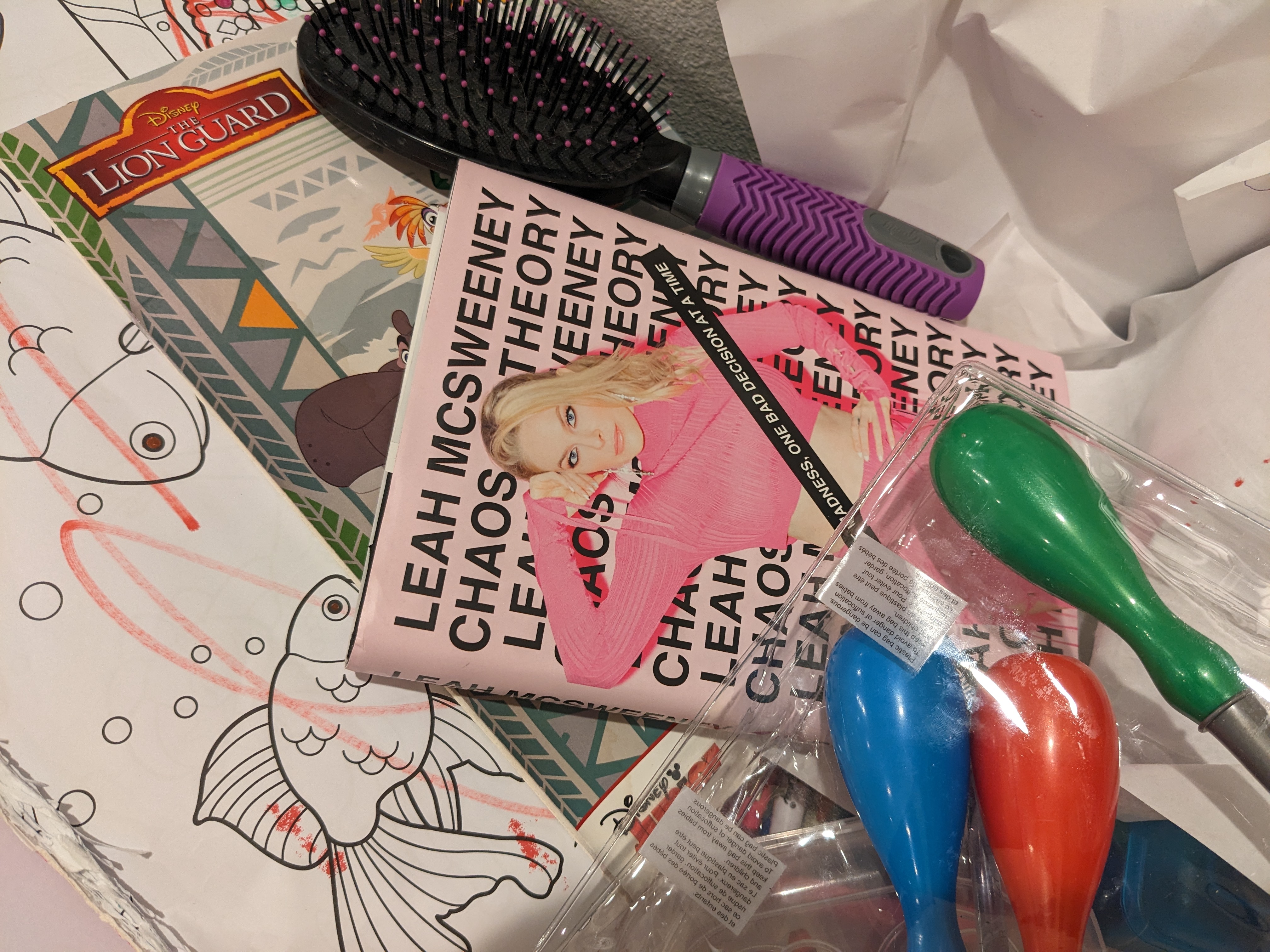 Chaos Theory book in a pile of kids art supplies